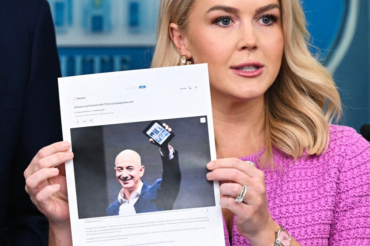 White House press secretary Karoline Leavitt holds up a printed article from 2021 about Amazon's Jeff Bezos during a briefing at the White House on April 29, 2025.